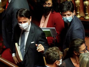 FILE PHOTO: Italian Prime Minister Giuseppe Conte and Health Minister Roberto Speranza leave after attending a session of the upper house of parliament, following the outbreak of the coronavirus disease (COVID-19), in Rome, Italy, July 28, 2020.