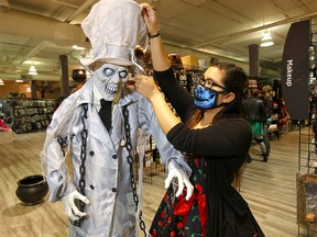 Sales associate Marianna Bakk of Halloween Alley located at Northland Mall looks over some of the merchandise for this year in Calgary on Tuesday, October 6, 2020.