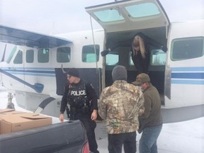 CP-Web.  Community members from Neskantaga First Nation unload a shipment of water from a plane in a Sunday, Oct. 25, 2020, handout photo. Residents left behind in a remote First Nation in northwestern Ontario that has been largely evacuated over a water crisis battled the cold and separation from relatives as they unloaded water deliveries and watched over the community on Sunday.