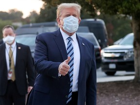 U.S. President Donald Trump gives a thumbs up towards reporters and photographers as he departs Walter Reed National Military Medical Center after a fourth day of treatment for the coronavirus disease (COVID-19) to return to the White House in Washington from the hospital in Bethesda, Maryland, U.S., October 5, 2020.