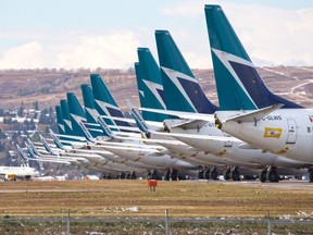 Sidelined WestJet Boeing 737 jets are stored on an unused runway at Calgary International Airport on Oct. 14, 2020.