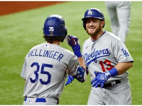 Oct 25, 2020; Arlington, Texas, USA; Los Angeles Dodgers first baseman Max Muncy (13) celebrates his home run against the Tampa Bay Rays with center fielder Cody Bellinger (35) during the fifth inning during game five of the 2020 World Series at Globe Life Field. Mandatory Credit: Kevin Jairaj-USA TODAY Sports ORG XMIT: IMAGN-431120