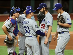 Oct 25, 2020; Arlington, Texas, USA; Los Angeles Dodgers manager Dave Roberts (30) takes starting pitcher Clayton Kershaw (22) out of the game during the sixth inning during game five of the 2020 World Series at Globe Life Field. Mandatory Credit: Kevin Jairaj-USA TODAY Sports ORG XMIT: IMAGN-431120