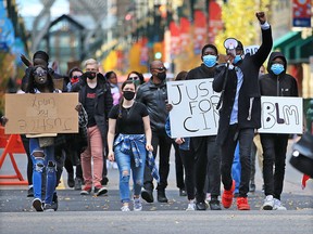 Black Lives Matter marchers walk down Stephen Avenue Mall on Saturday, Oct. 10, 2020.