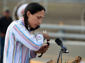 Seth Cardinal Dodginghorse cuts his braids as a part of his protest of the opening of the Tsuut'ina Trail section of the southwest Calgary ring road on Thursday, October 1, 2020. Dodginghorse said his family lost their family home and land to make way for the road.