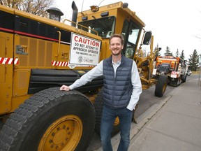 Roads maintenance manager Chris Hewitt poses with two machines in Calgary on Oct. 6, 2020. (Jim Wells / Postmedia)