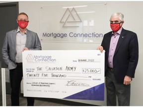 Josh Higgelke of  Mortgage Connection and fellow co-presenting sponsor Gerry Wood of Wood Automotive Group present a $25,000 cheque to the Salvation Army in support of the Day of A Thousand Lunches.