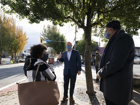 Local candidates Pam Alexis, Abbotsford-Mission, and Preet Rai, Abbotsford-West, look on as NDP Leader John Horgan main streets in Abbotsford, B.C., Wednesday, Oct. 21, 2020.
