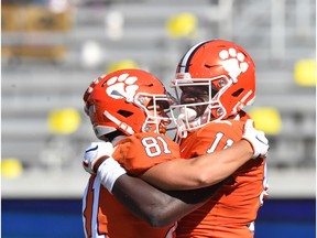 Oct 17, 2020; Atlanta, GA, USA;  Clemson Tigers wide receiver Ajou Ajou (11) celebrates with Clemson Tigers wide receiver Drew Swinney (81) after he scored a touchdown during the second half of an NCAA college football game at Bobby Dodd Stadium. Mandatory Credit: Hyosub Shin/Pool Photo-USA TODAY Sports