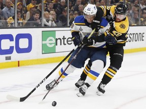 The St. Louis Blues’ Vince Dunn (29) battles for the puck with the Boston Bruins’ Joakim Nordstrom (20) during Game 7 of the Stanley Cup Final at TD Garden in Boston on June 12, 2019.