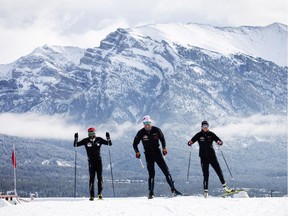 Olympians Dahria Beatty (R), Russell Kennedy (C) and legendary Paralympian, Brian McKeever, get back on snow for the first time in seven months thanks to the world-unique Frozen Thunder snow preservation project at the Canmore Nordic Centre, Monday, October 19, 2020. Photograph by Todd Korol