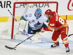 Flames forward Andrew Mangiapane prepares to take a shot on Canucks goalie Jacob Markstrom at the Saddledome on Saturday, Oct. 5, 2019.