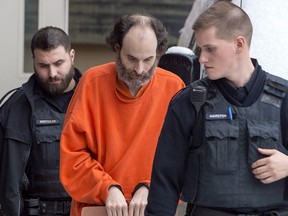 Matthew Vincent Raymond is escorted from provincial court in Fredericton on Friday, Feb. 8, 2019.