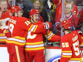 Calgary Flames Mikael Backlund celebrates with teammates after scoring a goal against the Boston Bruins during NHL hockey in Calgary on Friday February 21, 2020. Al Charest / Postmedia