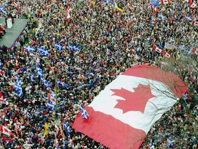 An oversized Maple Leaf flag marks a rally of huge crowds in Montreal in support of Canadian unity on Oct.  27, 1995, three days in advance of the Quebec referendum that narrowly rejected separation.