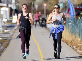 Maura Green, left, and Rachel Hall enjoy a run in spring-like weather near Edworthy Park in Calgary on Tuesday, Oct. 27, 2020. Temperatures are expected to rise into the 20s by the weekend.