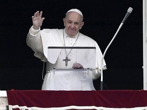Pope Francis waves to the faithfuls as he delivers the Sunday Angelus prayer from his studio window overlooking Saint Peter's Square, at the Vatican on March 01, 2020.