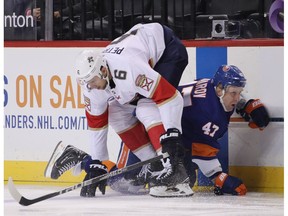 NEW YORK, NEW YORK - OCTOBER 24: Alex Petrovic #6 of the Florida Panthers checks Leo Komarov #47 of the New York Islanders during the second period at the Barclays Center on October 24, 2018 in the Brooklyn borough of New York City.