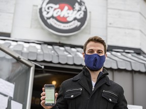 Griffin Smith, co-founder of the QResponse app, poses for a photo outside Tokyo Street Market on Friday, November 20, 2020.