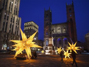 CP-Web.  Christmas decorations are seen in front of the Notre-Dame Basilica in Montreal, Thursday, Nov. 19, 2020. Members of religious minority groups in Quebec are decrying the provincial government's plan to allow Christmas-time gatherings in the midst of the COVID-19 pandemic, calling the move a sign of a double standard.