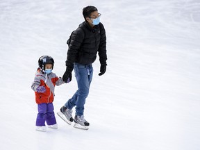Jonathan Chan and his three-year-old daughter Allison spend the day ice-skating at Olympic Plaza on Friday, November 27, 2020.