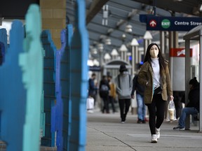 A masked pedestrian walks in Centre Street station in downtown Calgary on Friday, November 27, 2020.