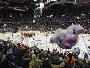 Calgary Hitmen fans celebrate a goal by Carson Focht during the Teddy Bear Toss game against Red Deer Rebels at the Saddledome on Sunday, Dec. 1, 2019.