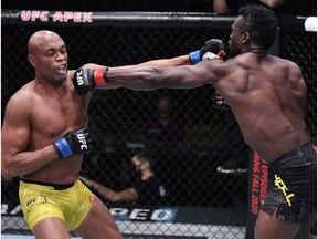 LAS VEGAS, NEVADA - OCTOBER 31: In this handout image provided by UFC, (L-R) Anderson Silva of Brazil and Uriah Hall of Jamaica trade punches in a middleweight bout during the UFC Fight Night event at UFC APEX on October 31, 2020 in Las Vegas, Nevada.