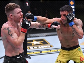 LAS VEGAS, NEVADA - NOVEMBER 14: In this handout image provided by UFC, (R-L) Rafael Dos Anjos of Brazil punches Paul Felder in a lightweight fight during the UFC Fight Night event at UFC APEX on November 14, 2020 in Las Vegas, Nevada.