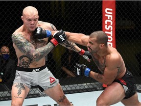 LAS VEGAS, NEVADA - NOVEMBER 28: In this handout image provided by the UFC, Devin Clark (R) punches Anthony Smith in their light heavyweight bout during the UFC Fight Night at UFC APEX on November 28, 2020 in Las Vegas, Nevada.