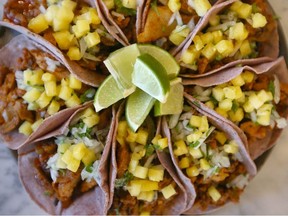 Al pastor tacos (chili marinated pork with pineapple jalapeno aioli, salsa morita) is displayed at Con Mi Taco in Calgary. Potential customers can observe part of the cooking process as the store is located on the corner of busy 9 Ave and 1 St SW. Jim Wells/Postmedia