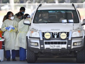 Health workers test the South Australia public at a drive-through coronavirus disease (COVID-19) testing site in Adelaide, Australia, November 19, 2020.