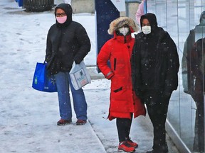 Transit riders bundle up against the wind and snow in Sunridge as a blast of winter hit Calgary on Saturday, November 7, 2020.
