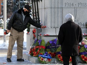 Reid Galbraith places a poppy on the cenotaph in Central Memorial Park on Remembrance Day Wednesday, November 11, 2020. The COVID-19 pandemic meant large public gatherings were not permitted.

Gavin Young/Postmedia