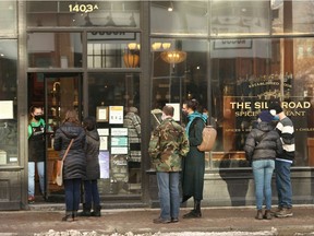 Customers line up outside The Silk Road Spice Merchant shop in Inglewood on 9 Ave SE Calgary on Saturday, November 14, 2020. While some have called for a lockdown to slow the spread of COVID-19, the province has chosen to keep the economy open and running.