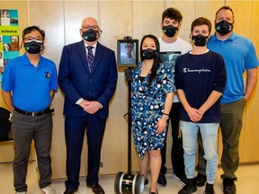 Cody Kirk attends a press conference via his new Double 2 telepresence robot, which is like an iPad on wheels. He will use the robot to attend classes from his home. Pictured from left is Donald Huang, Darryl Graham, Cody Kirk on the Double 2, Angela Lee, Marcus Kittelson, Matthew Zuberec and Michael MacDonald.