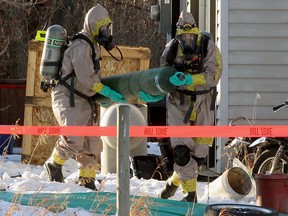 Emergency crews wearing HAZMAT suits are seen on a rural property east of Delacour as an ongoing RCMP investigation continues.  Wednesday, November 25, 2020.