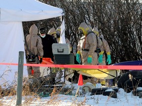 Emergency crews wearing HAZMAT suits are seen on a rural property east of Delacour as an ongoing RCMP investigation continues.  Wednesday, November 25, 2020.