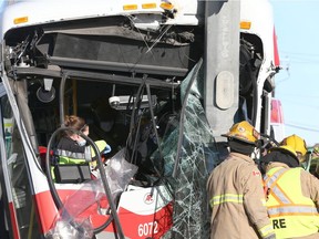 Emergency crews work to free a bus driver pinned in the cab area of a bus following a collision with a truck on 52nd Street and 90th Avenue S.E. in Calgary on Thursday, Nov. 26, 2020.