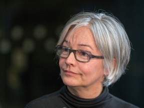 Calgary City councillor Druh Farrell talks with media outside council chambers on Wednesday, February 12, 2020.