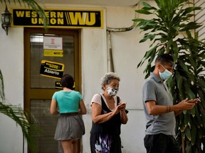Cubans queue outside a Western Union office in Havana, on Oct. 28.