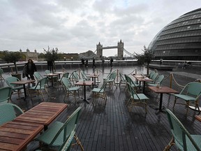 Empty tables are seen outside a restautrant with Tower Bridge in the background in London on November 1, 2020 as England prepares to enter into a second coronavirus lockdown in an effort to stem soaring infections. - A new four-week coronavirus lockdown in England will be extended if it fails to reduce infection rates, the government said Sunday, as it faced criticism over the abrupt decision to shut down again. The second national lockdown, hastily announced late Saturday following warnings hospitals could become overwhelmed within weeks, is set to come into force from Thursday and end on December 2.