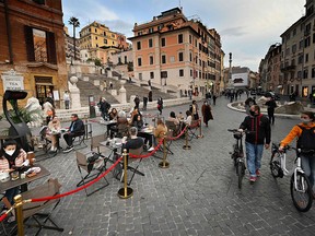 People enjoy a drink at a Tea Room's terrace on Piazza di Spagna in downtown Rome on November 14, 2020, during the COVID-19 pandemic caused by the novel coronavirus.