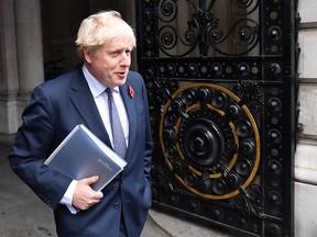 (FILES) In this file photo taken n November 10, 2020, Britain's Prime Minister Boris Johnson arrives back at Downing Street in London.