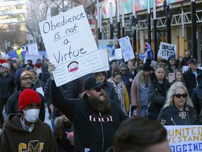 Hundreds of people protest mandatory masks at Calgary city hall on Saturday, Nov. 21, 2020.