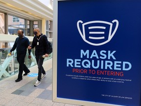 A sign reminds pedestrians of the Calgary mask bylaw at the entrance to Bankers Hall in Calgary on Wednesday, November 4, 2020.