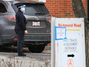 Cars are directed inside for COVID-19 testing at the Richmond Road testing site in Calgary on Sunday, November 8, 2020. The province is experiencing a dramatic surge in COVID-19 cases.