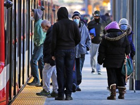 Masked commuters travel in downtown Calgary on Monday, November 9, 2020.