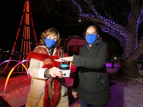 L-R, CEO, Chair and President ATCO, Nancy Southern and Retired Corporal in the Canadian Armed Forces and resident, Maria Derman hit the button to lift the spirits of Veterans of the Canadian Armed Forces who live at ATCO Village on Sunday evening with an impressive light display that is synchronized to music and will be available for Calgarians to enjoy throughout the holiday season in Calgary on Sunday, November 22, 2020.