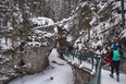 An image of people hiking in Johnston Canyon in winter in Alberta, Canada.